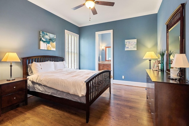 bedroom featuring baseboards, ensuite bath, wood finished floors, and ornamental molding