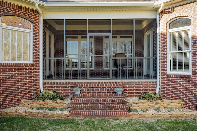 property entrance featuring brick siding