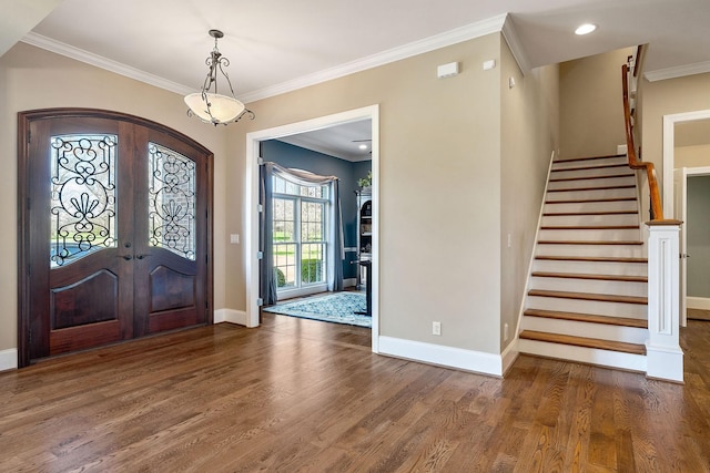 entryway featuring baseboards, arched walkways, wood finished floors, and french doors