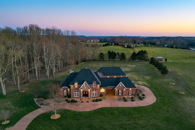aerial view at dusk featuring a rural view