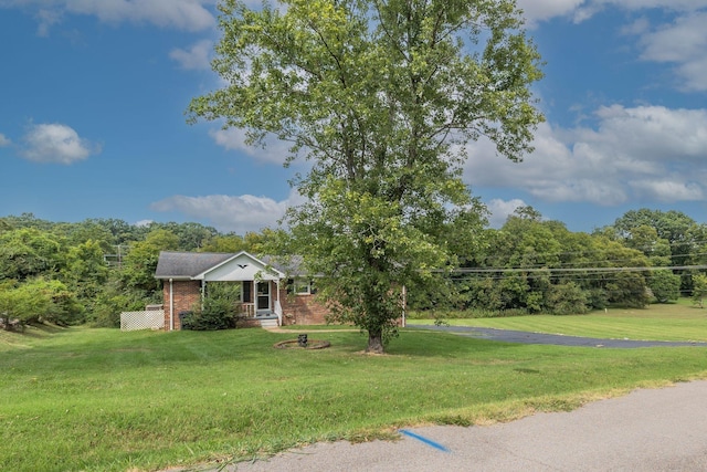view of front of house featuring brick siding, a porch, and a front lawn