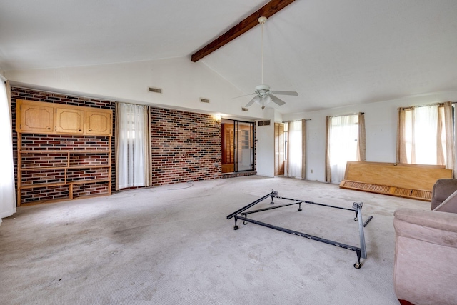 unfurnished living room featuring high vaulted ceiling, visible vents, beamed ceiling, a ceiling fan, and brick wall