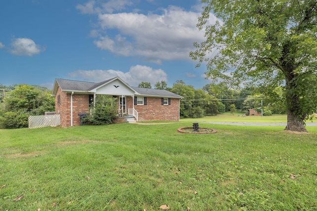 view of front of property featuring brick siding and a front yard