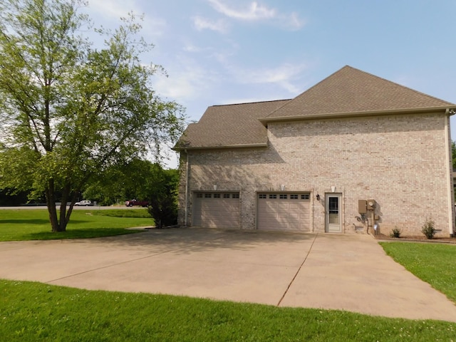 423 Carters Creek Pike, Columbia, TN 38401 - view of home's exterior featuring a garage, concrete driveway, roof with shingles, a yard, and brick siding