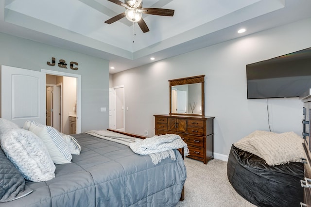 bedroom featuring baseboards, a raised ceiling, recessed lighting, and light colored carpet