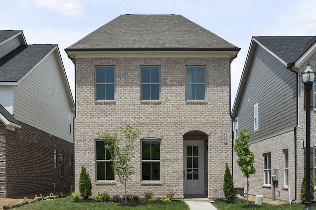 162 Oasis Dr, La Vergne, TN 37086 - view of front of home featuring brick siding, a shingled roof, and central AC unit