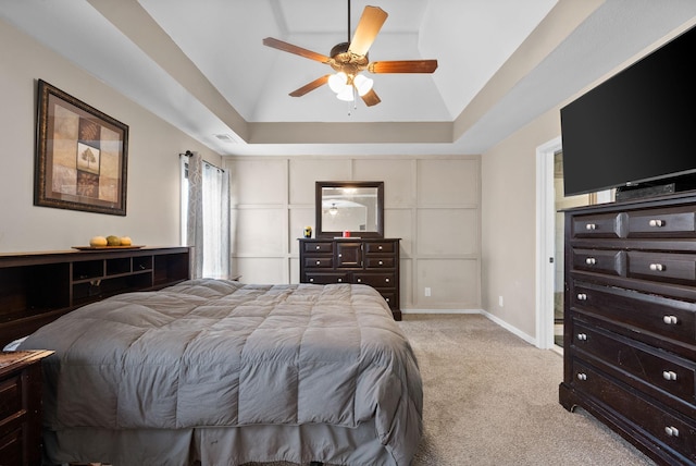 bedroom with visible vents, baseboards, a raised ceiling, lofted ceiling, and carpet floors