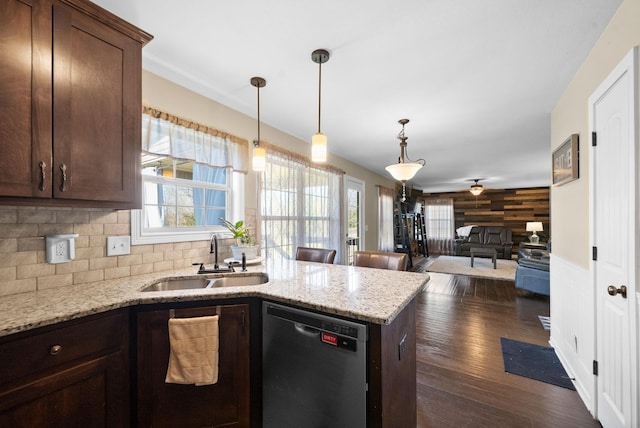 kitchen with a sink, a ceiling fan, dishwasher, a peninsula, and a healthy amount of sunlight