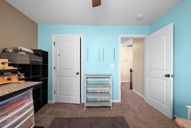 interior space featuring baseboards, carpet flooring, and a ceiling fan