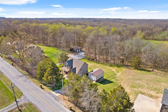 drone / aerial view featuring a forest view