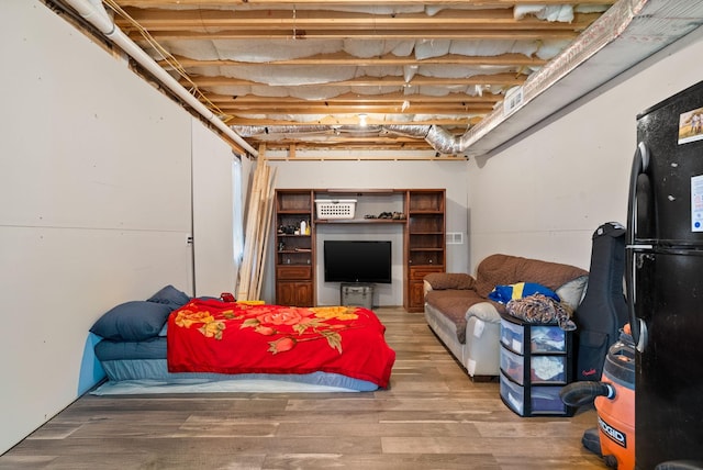 interior space with freestanding refrigerator and wood finished floors
