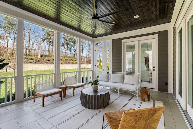 sunroom with a ceiling fan and outdoor lounge area