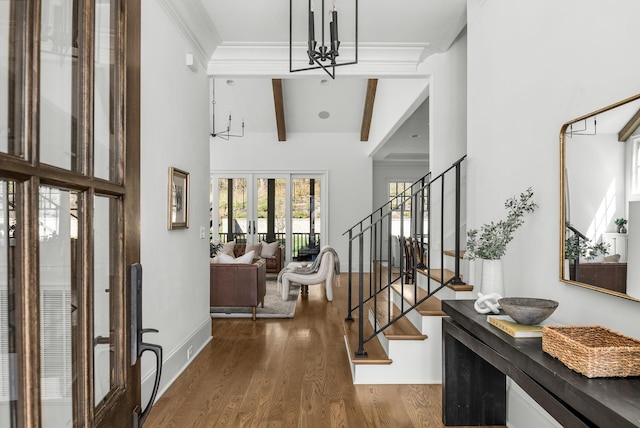 foyer featuring high vaulted ceiling, beam ceiling, stairway, dark wood-type flooring, and ornamental molding
