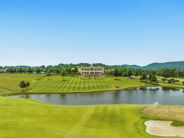 view of community featuring golf course view and a water view