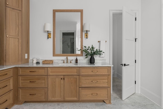 bathroom featuring vanity, toilet, baseboards, marble finish floor, and walk in shower