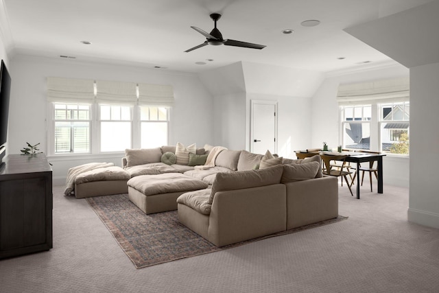 living room with baseboards, crown molding, carpet flooring, and a ceiling fan