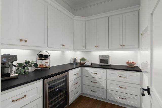 kitchen with white cabinetry, dark countertops, wine cooler, and dark wood finished floors