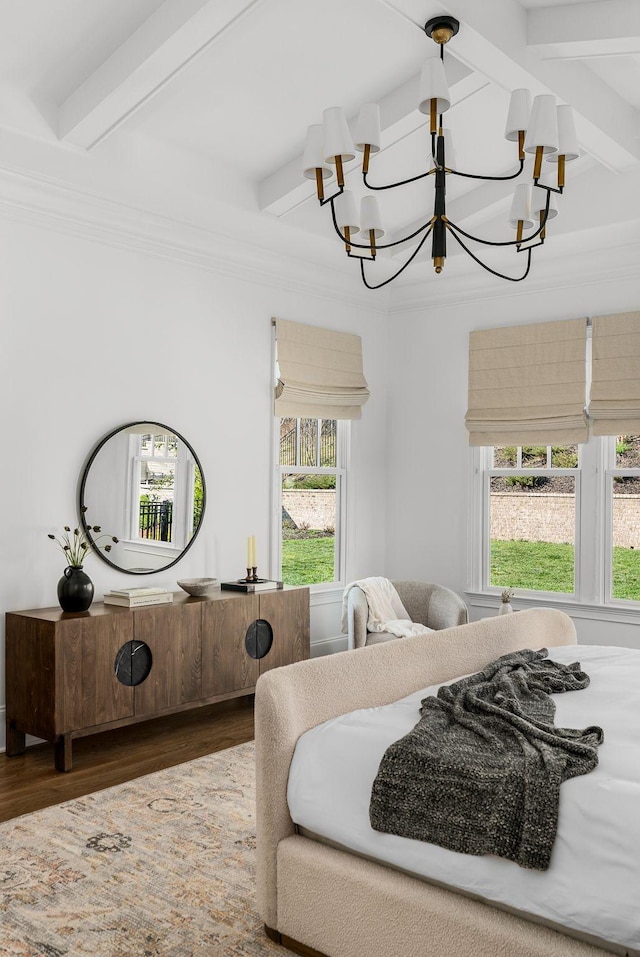bedroom with beamed ceiling, a notable chandelier, crown molding, and wood finished floors