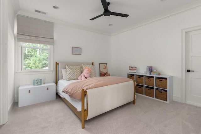 carpeted bedroom with visible vents, ceiling fan, and ornamental molding
