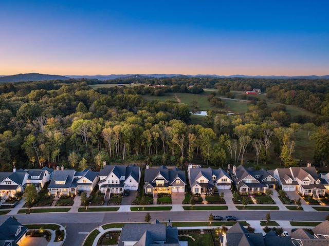 aerial view featuring a forest view and a residential view
