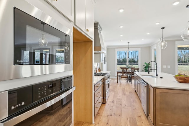 6477 Simmons Acres Ln, Lascassas, TN 37085 - kitchen with appliances with stainless steel finishes, light wood-style floors, brown cabinetry, plenty of natural light, and ornamental molding