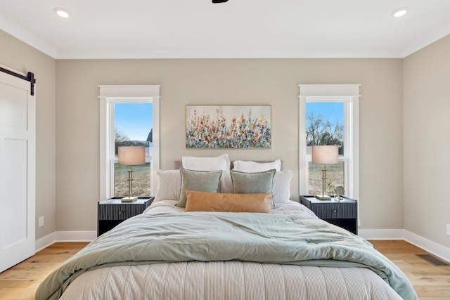 6477 Simmons Acres Ln, Lascassas, TN 37085 - bedroom featuring a barn door, wood finished floors, and recessed lighting