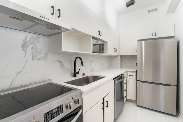 105 Leake Ave Unit 44, Nashville, TN 37205 - kitchen featuring under cabinet range hood, marble finish floor, a sink, visible vents, and appliances with stainless steel finishes