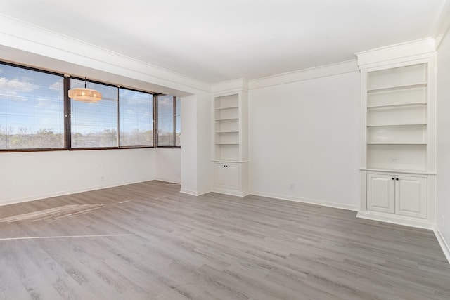 105 Leake Ave Unit 44, Nashville, TN 37205 - unfurnished room featuring ornamental molding, baseboards, built in shelves, and wood finished floors