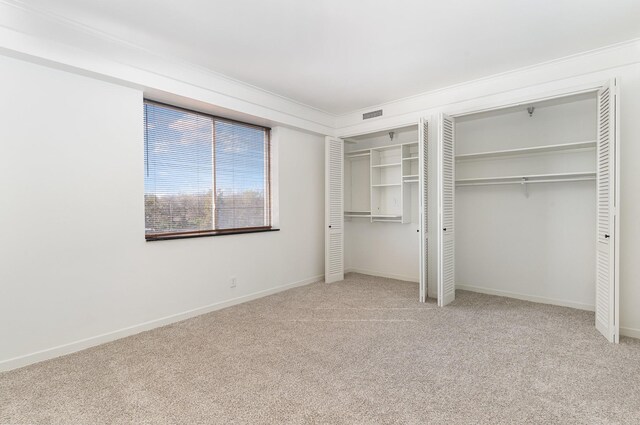 105 Leake Ave Unit 44, Nashville, TN 37205 - unfurnished bedroom featuring baseboards, multiple closets, visible vents, and carpet