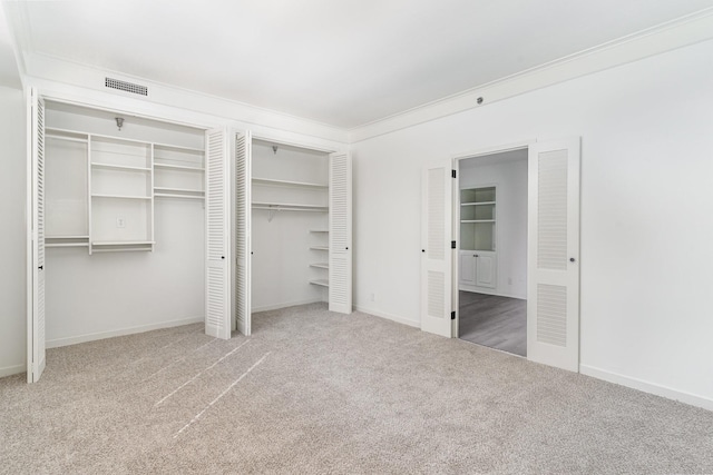 105 Leake Ave Unit 44, Nashville, TN 37205 - unfurnished bedroom featuring carpet flooring, multiple closets, ensuite bath, visible vents, and ornamental molding