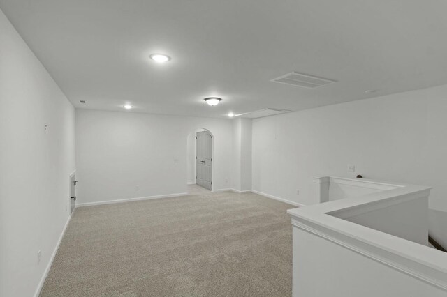 166 Oasis Dr, La Vergne, TN 37086 - below grade area featuring visible vents, arched walkways, baseboards, and light carpet