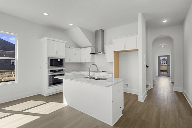 166 Oasis Dr, La Vergne, TN 37086 - kitchen featuring dark wood-type flooring, a sink, white cabinets, appliances with stainless steel finishes, and wall chimney exhaust hood