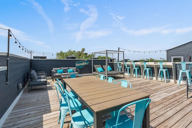 wooden terrace with outdoor lounge area and outdoor dining space