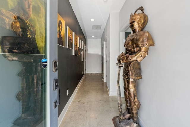corridor featuring concrete flooring, baseboards, visible vents, and recessed lighting