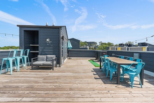 wooden deck with central AC unit and outdoor dining space