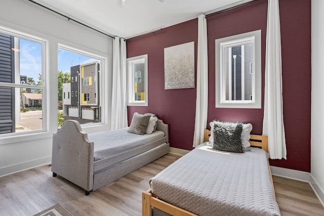 bedroom with baseboards and light wood-type flooring