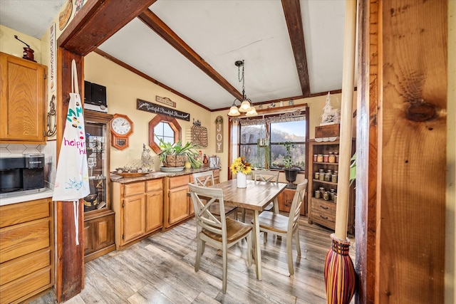 dining area featuring an inviting chandelier, lofted ceiling with beams, and light wood-type flooring