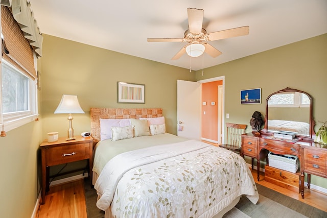 bedroom with baseboards, ceiling fan, and wood finished floors