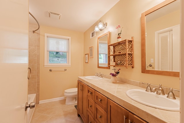 bathroom featuring tile patterned floors, visible vents, and a sink