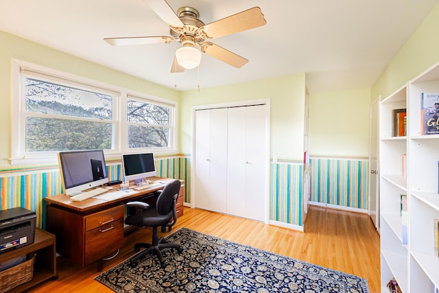 office space with wallpapered walls, baseboards, ceiling fan, and wood finished floors