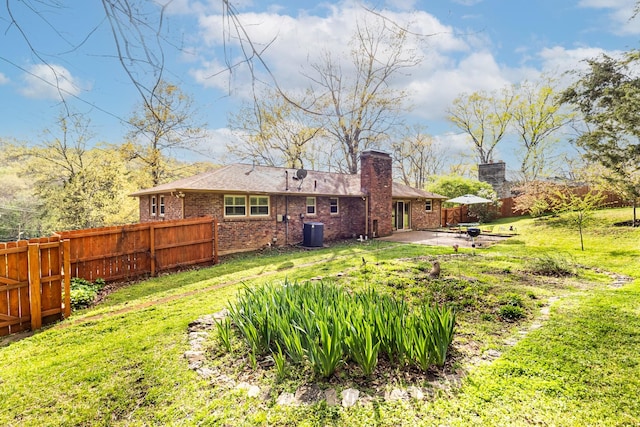 view of yard featuring fence, cooling unit, and a patio area