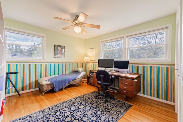 bedroom featuring wallpapered walls, baseboards, ceiling fan, and wood finished floors