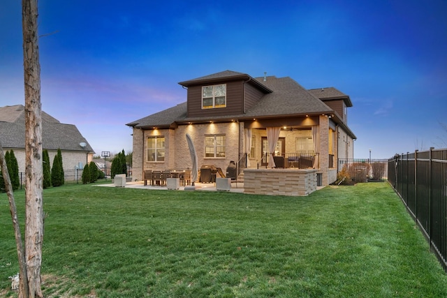 118 Newnham Bridge Dr, Nolensville, TN 37135 - back of property at dusk with a fenced backyard, a patio area, and a lawn