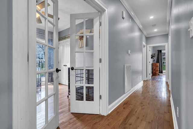 hall with baseboards, visible vents, ornamental molding, recessed lighting, and hardwood / wood-style floors