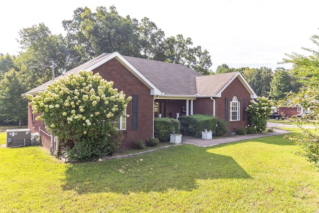 996 Iron Hill Rd, Burns, TN 37029 - view of front of house with brick siding, a shingled roof, and a front lawn