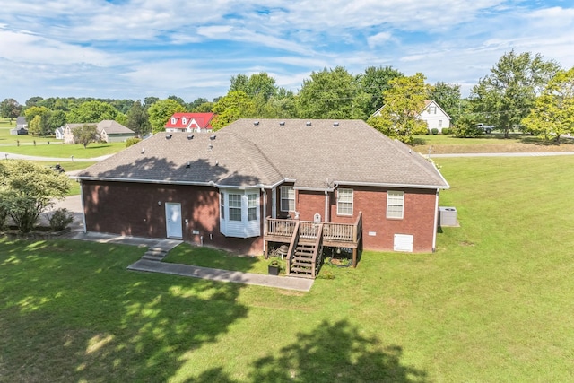 996 Iron Hill Rd, Burns, TN 37029 - back of property with a wooden deck, stairway, brick siding, roof with shingles, and a lawn