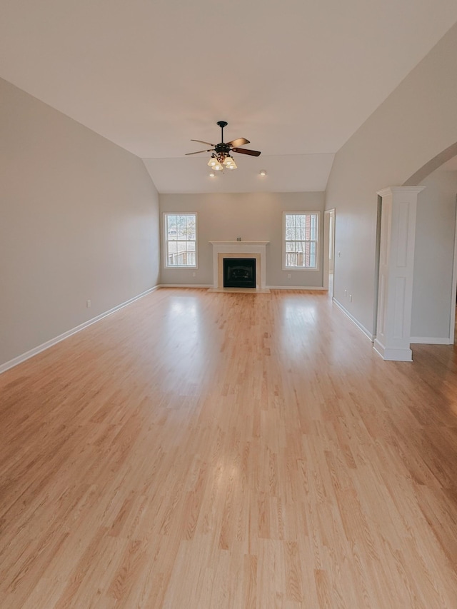 996 Iron Hill Rd, Burns, TN 37029 - unfurnished living room with vaulted ceiling, baseboards, light wood finished floors, ceiling fan, and a fireplace
