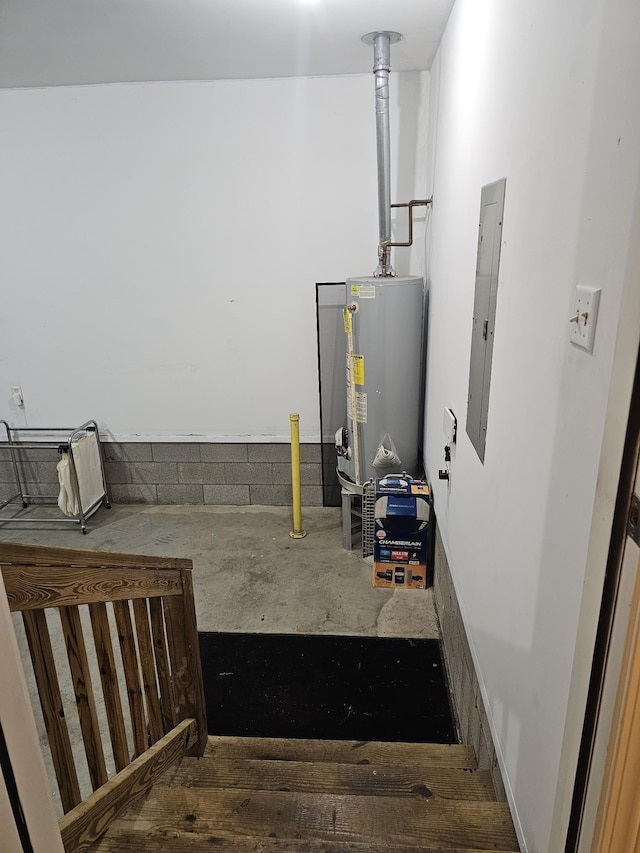 996 Iron Hill Rd, Burns, TN 37029 - stairs featuring electric panel, unfinished concrete floors, and gas water heater