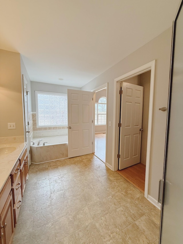 996 Iron Hill Rd, Burns, TN 37029 - bathroom with baseboards, a wealth of natural light, a garden tub, and vanity