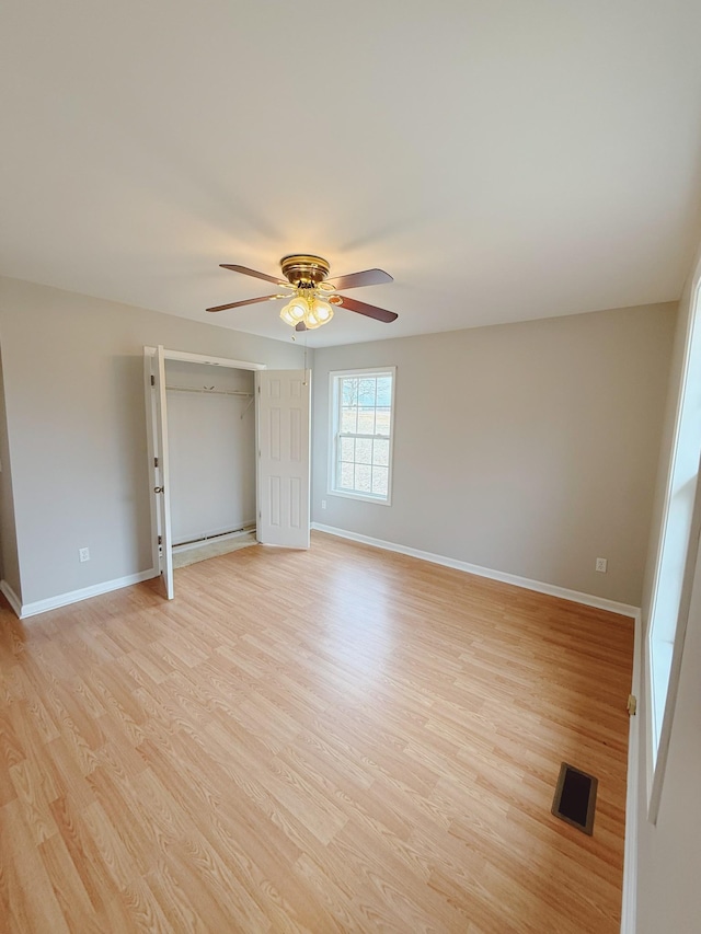 996 Iron Hill Rd, Burns, TN 37029 - unfurnished room with baseboards, light wood-style flooring, ceiling fan, and visible vents